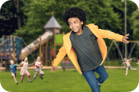 Smiling child running in a playground